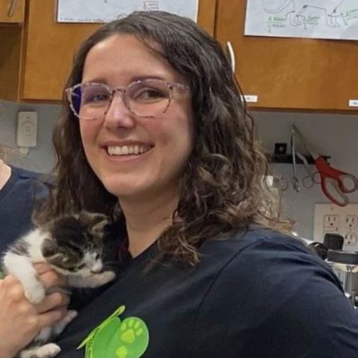 smiling woman holding a kitten